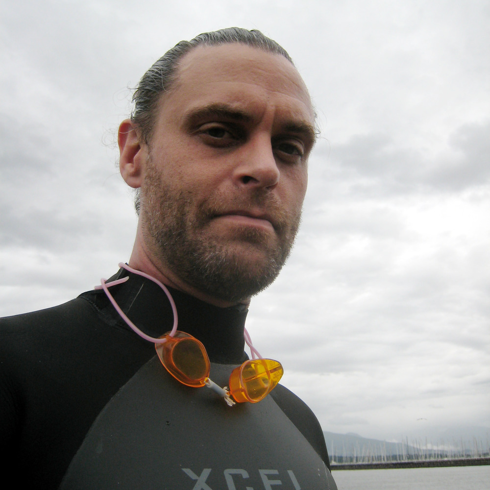 Photo of Dorian in a wetsuit, at the beach